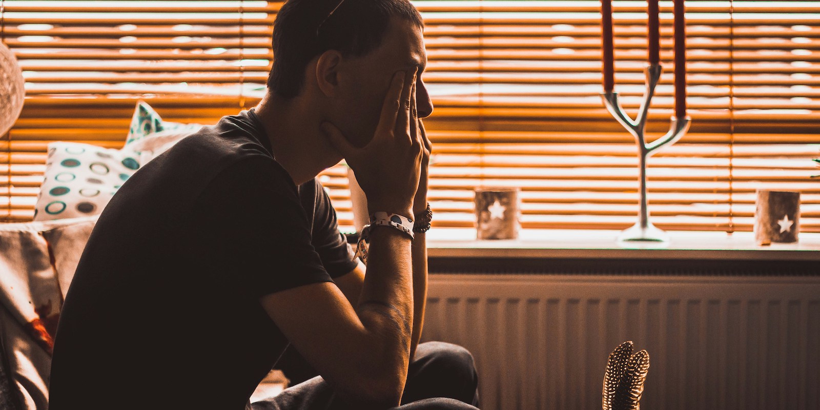 exhausted man with hands on face